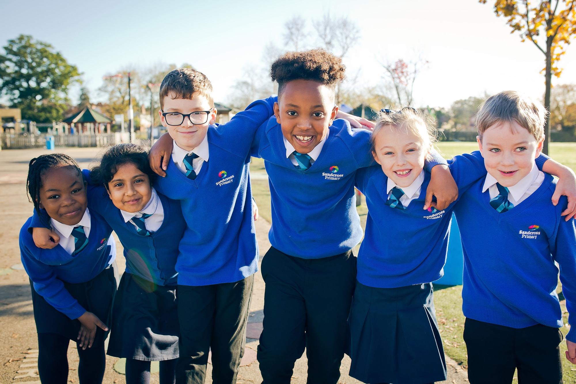 Children in the playground with arms around each other